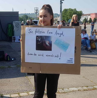 Junge Dame trägt ein Plakat